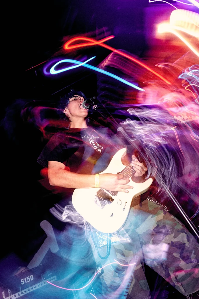 XCOMM guitarist with light trails, by Maya Sacks